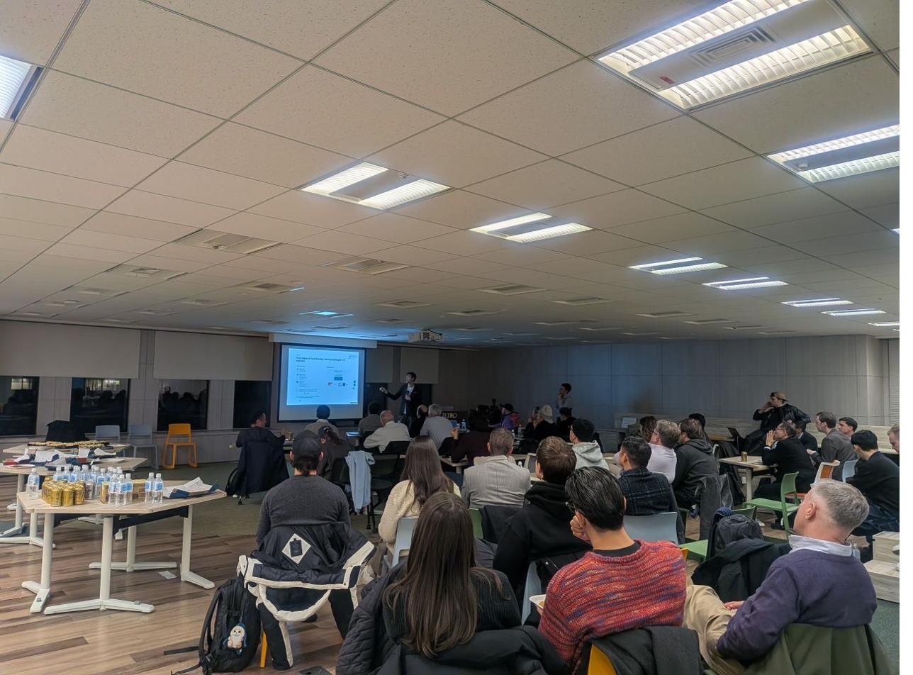 Japan Angels gathering with members in a wide presentation room